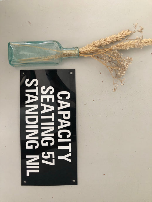 Vintage ‘Seating Capacity' sign